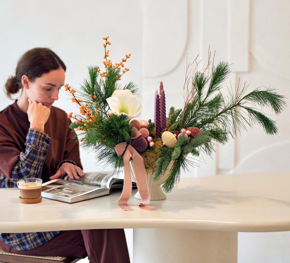 
                  
                    Christmas arrangement made of fresh greenery with amaryllis and candles in a decorative stoneware bowl modern floristry by Urban Bloom
                  
                