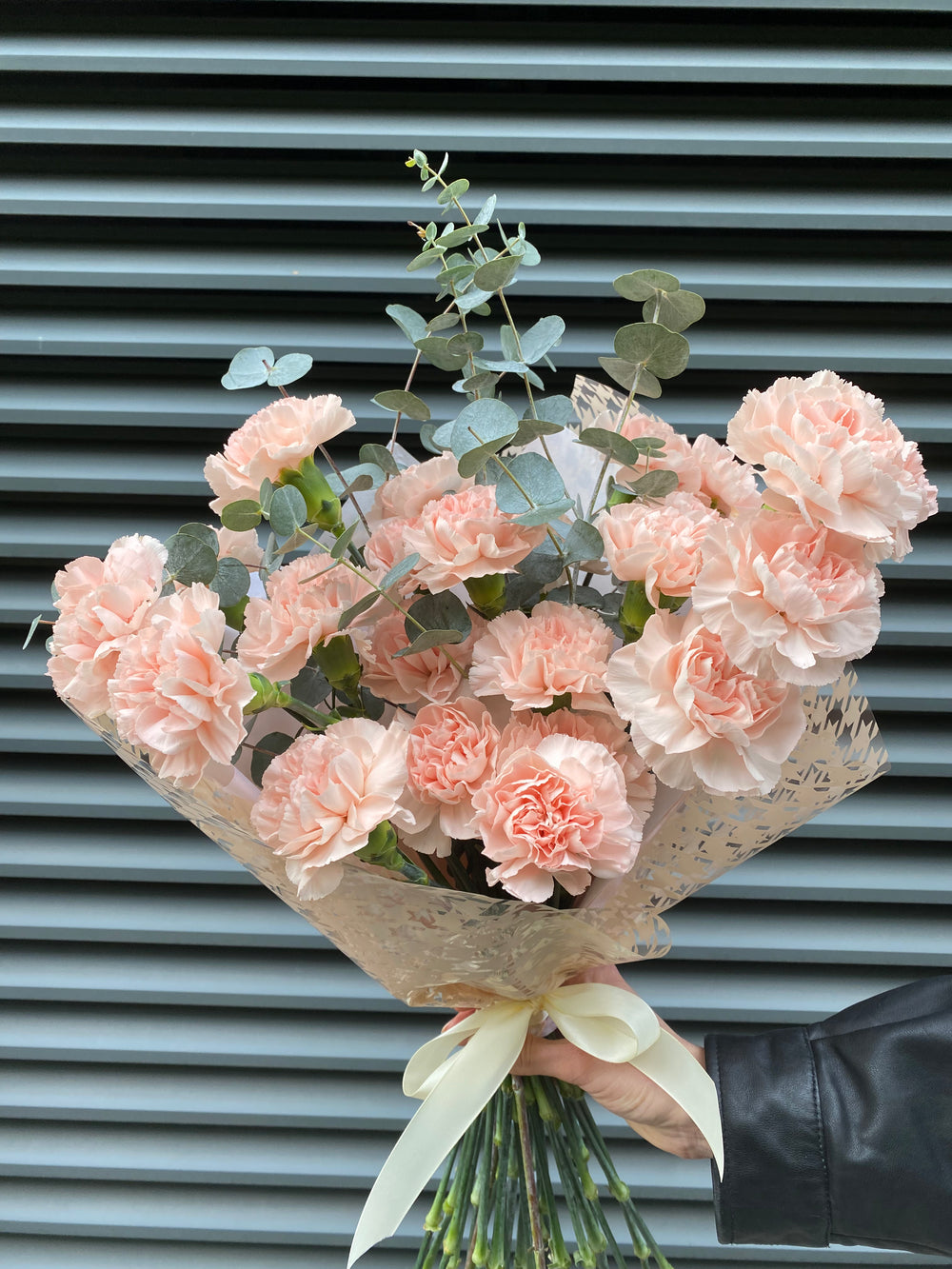 Bouquet of soft carnations with eucalyptus